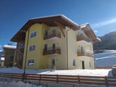 a house in the snow with a fence at B&B Le Ciorciole in Tesero