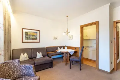 a living room with a couch and a table at Appartements Villa Fortuna in Tirolo