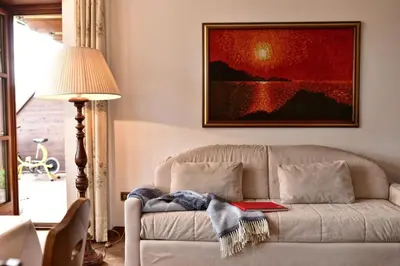 a small bedroom with a bunk bed and a desk at Appartements Villa Fortuna in Tirolo