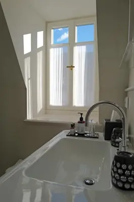 a kitchen with a sink and a window at Steinach Townhouse Meran in Merano