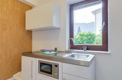a kitchen with a sink and a window at Peters Guest House in Bolzano