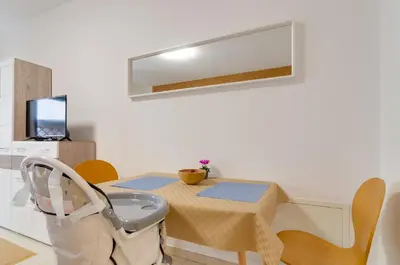 a room with a table with a chair and a mirror at Peters Guest House in Bolzano