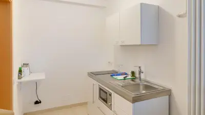 a kitchen with a sink and a counter top at Peters Guest House in Bolzano
