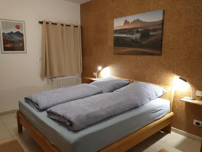 a bedroom with a bed with two pillows on it at Peters Guest House in Bolzano