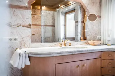 a bathroom with a sink and a mirror at Ciasa Scjadu in San Cassiano