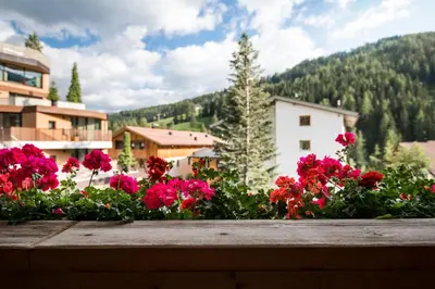 a bunch of flowers in front of a building at Ciasa Scjadu in San Cassiano