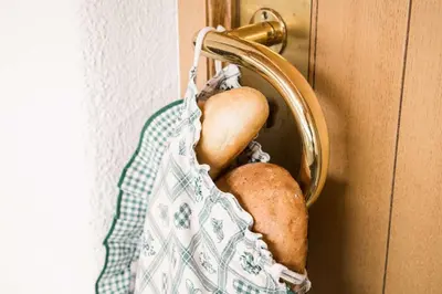 a bag of potatoes hanging from a door knob at Residence Ciasa Giardun in La Villa