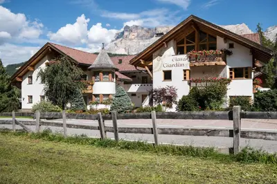 a house with a fence in front of it at Residence Ciasa Giardun in La Villa