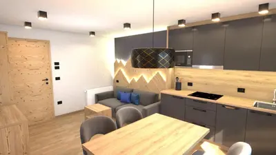 a kitchen with a table and chairs and a counter at Residence Garni Stella in San Vigilio Di Marebbe