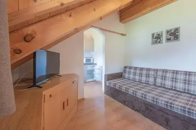 a living room with a couch and a flat screen tv at Residence Garni Stella in San Vigilio Di Marebbe