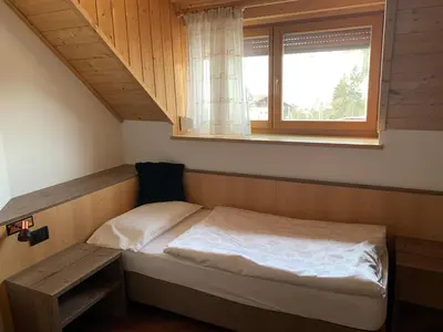 a small bed in a room with a window at Residence Garni Stella in San Vigilio Di Marebbe