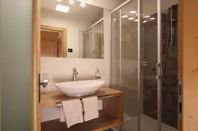a bathroom with a sink and a shower at Residence Garni Stella in San Vigilio Di Marebbe