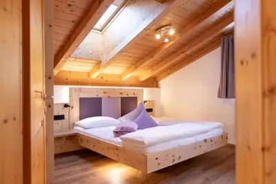 a kitchen with white cabinets and a wooden ceiling at Ferienwohnungen Zeppenhof in Santa Valburga St. Walburg