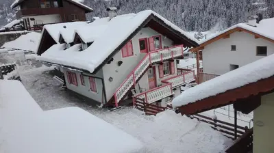 a group of buildings covered in snow at Appartamento Col Val di Fassa con giardino BAGNI RINNOVATI 2023 in Campitello di Fassa