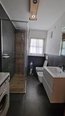 a bathroom with a shower and a toilet and a sink at Appartamento Col Val di Fassa con Terrazza BAGNI RINNOVATI 2023 in Campitello di Fassa