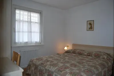 a bedroom with a bed and a window at Appartamento Col Val di Fassa con Terrazza BAGNI RINNOVATI 2023 in Campitello di Fassa