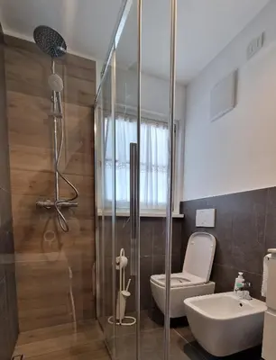a bathroom with a shower and a toilet and a sink at Appartamento Col Val di Fassa con Terrazza BAGNI RINNOVATI 2023 in Campitello di Fassa