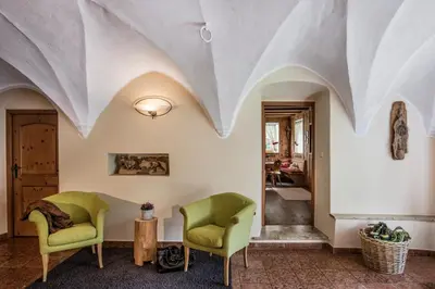 a living room with two chairs and a table at Pension Moarhof in Campo Tures