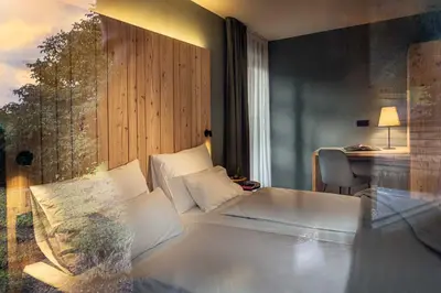 a room with a bed and a desk and a window at Pension Moarhof in Campo Tures