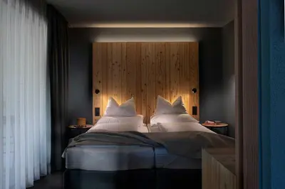 a bedroom with a large bed with white pillows at Pension Moarhof in Campo Tures