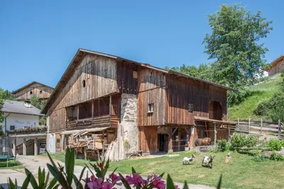 an old barn with animals in front of it at Ferienbauernhof Wieserhof in Fiè