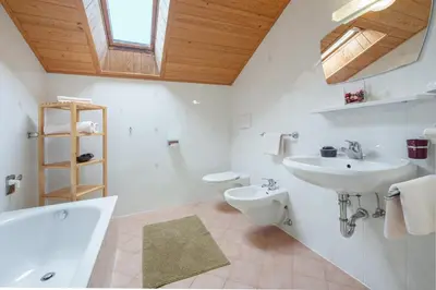 a white bathroom with a sink and a toilet at Ferienbauernhof Wieserhof in Fiè