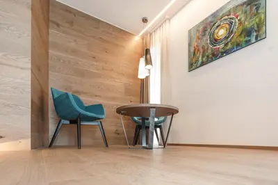a room with two chairs and a table and a painting at Gasthof Sonne snc in Sarntal