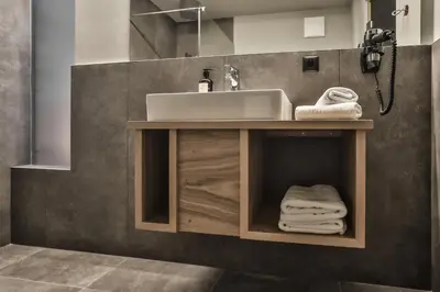a bathroom with a sink and a counter with towels at Gasthof Sonne snc in Sarntal