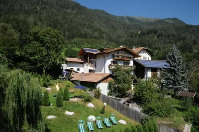 an exterior view of a building with a stone wall at Chalet & Appartement Zingerlehof Trens in Campo di Trens