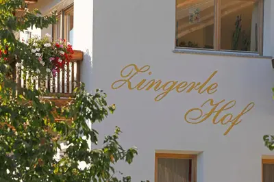 a sign on the side of a white building at Chalet & Appartement Zingerlehof Trens in Campo di Trens