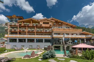 a hotel with a pool and a resort at Croce Bianca Leisure & Spa Hotel in Canazei