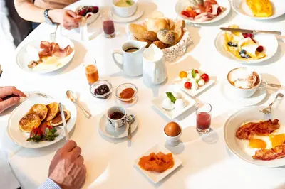a kitchen with a counter with a bowl of fruit at Croce Bianca Leisure & Spa Hotel in Canazei