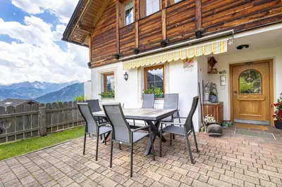 a table and chairs on a patio with mountains at Agriturismo Al Cir in San Martino in Badia
