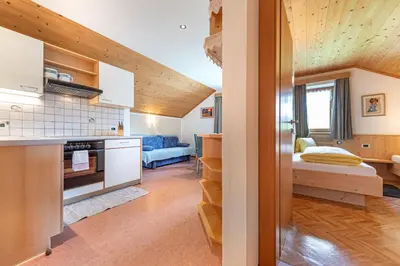 a small kitchen and living room in a tiny house at Agriturismo Al Cir in San Martino in Badia