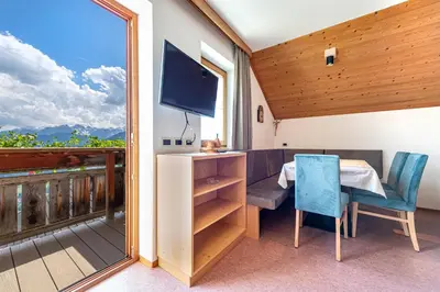 a room with a table and a tv on a balcony at Agriturismo Al Cir in San Martino in Badia