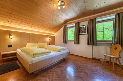 a bedroom with a large bed in a wooden ceiling at Agriturismo Al Cir in San Martino in Badia