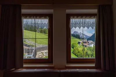 two windows with a view of a mountain at Agriturismo Al Cir in San Martino in Badia