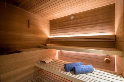 a sauna with two blue towels sitting in it at Hotel Colfosco in San Martino di Castrozza