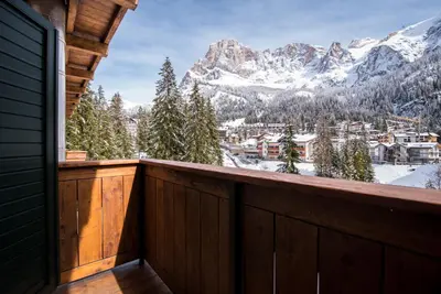a balcony with a view of the mountains at Hotel Colfosco in San Martino di Castrozza
