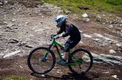 a person riding a bike on a dirt road at GH Hotel Fratazza in San Martino di Castrozza