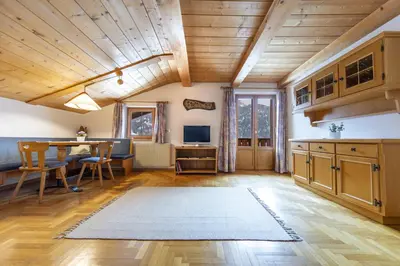 a kitchen with wooden ceilings and a table and chairs at Panorama Apartment Pizaut in Ortisei