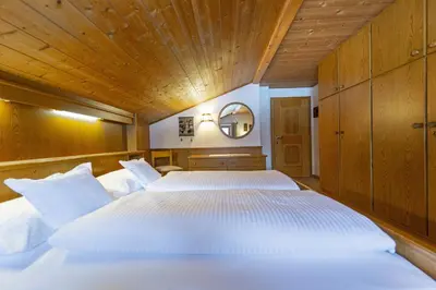 a bedroom with two white beds in it at Panorama Apartment Pizaut in Ortisei