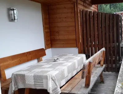 a table and benches on the porch of a cabin at Ober-Gruberhof in Ridanna