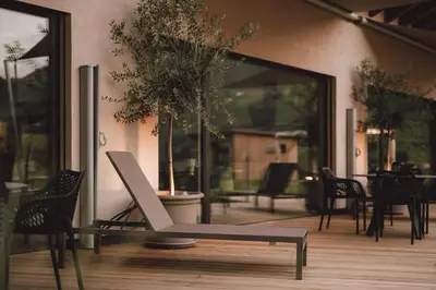 a chair sitting on a wooden floor in a room at Pitzner - Winery & Suites in Cornedo all'Isarco