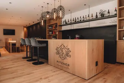 a bar with a sign that reads friger at Pitzner - Winery & Suites in Cornedo all'Isarco