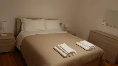a bedroom with a bed with two towels on it at CASA MASCIA in Cencenighe