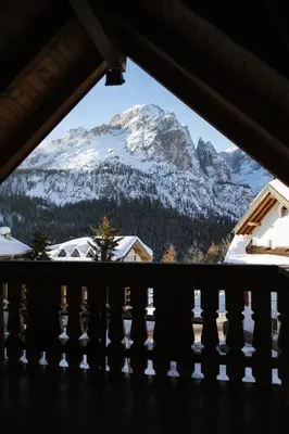 a view of a snow covered mountain from a balcony at Garni Fany in Colfosco