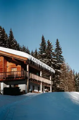 a log cabin with snow on the ground at Karlshütte in Avelengo