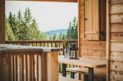 a wooden table on a porch with a window at Karlshütte in Avelengo