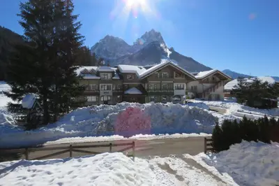 a lodge in the mountains covered in snow at Residence Holiday in Pozza di Fassa